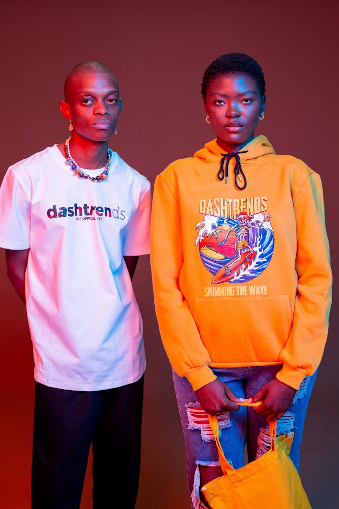 why-choose-us Fashion portrait of models in colorful outfits with dynamic red background, showcasing trendy streetwear.